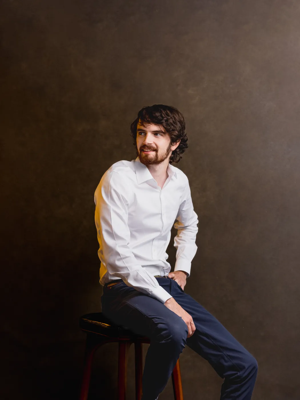 Studio portrait, seated on a stool