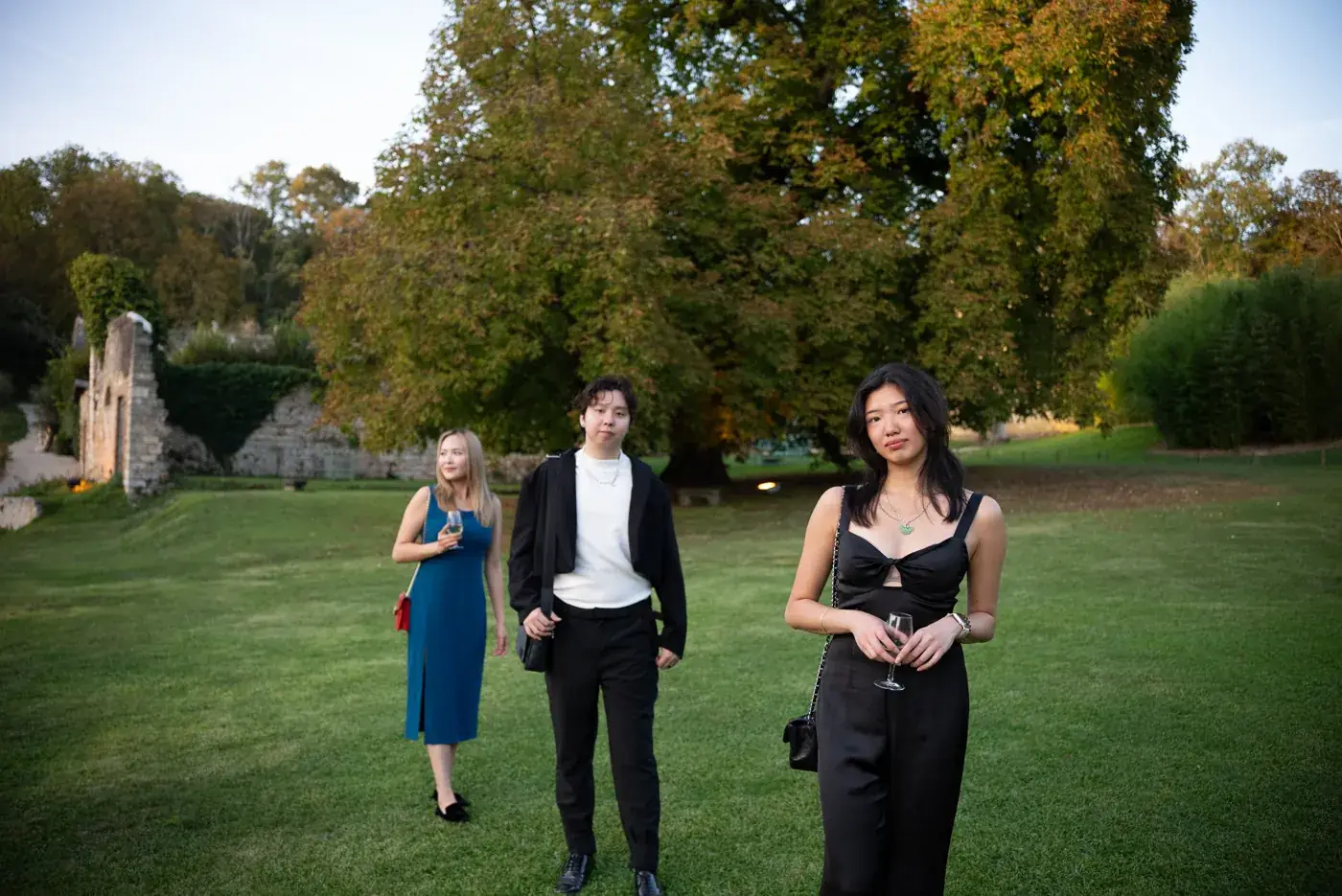 Group of friends walking across a lawn