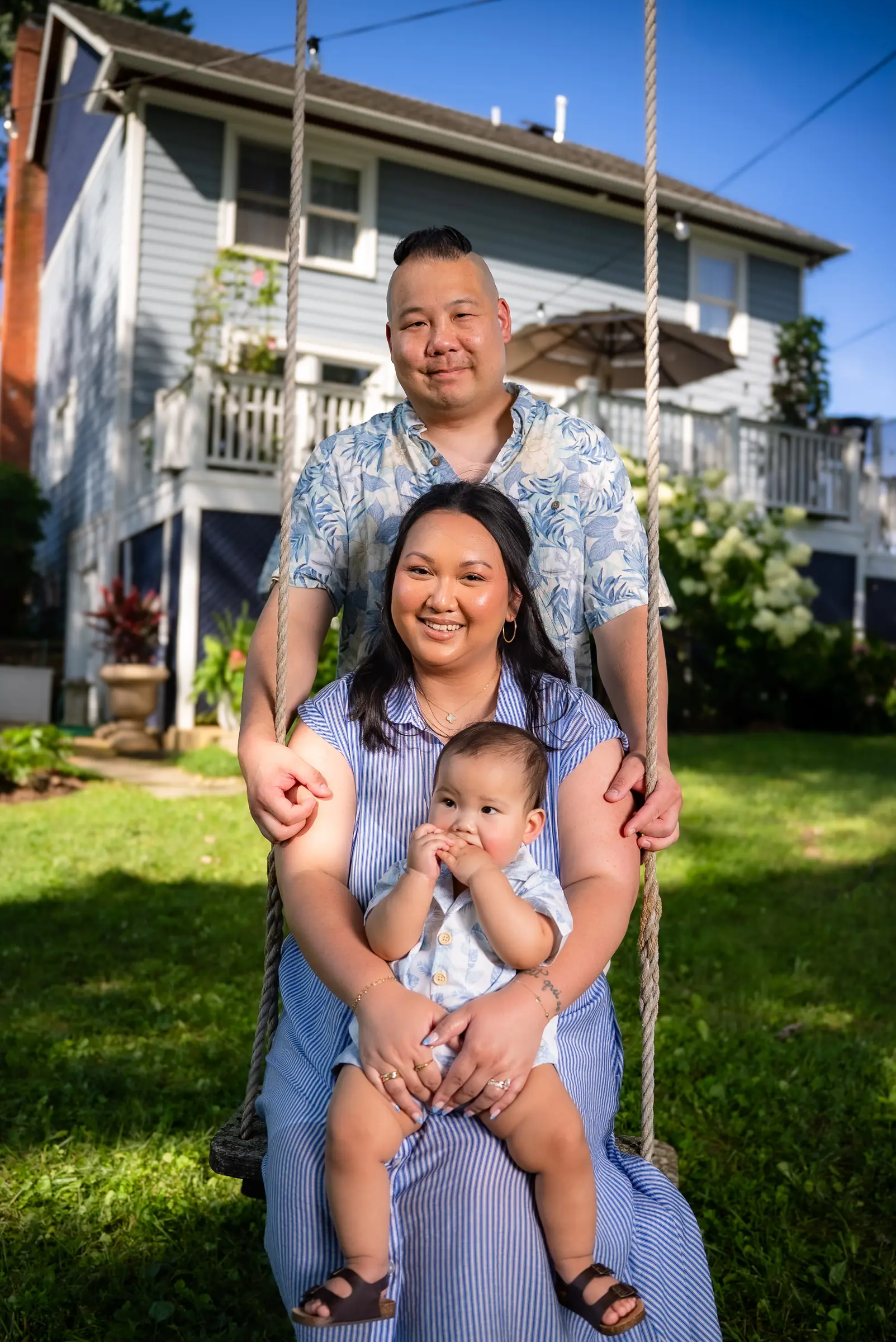 Parents and their baby on a garden swing