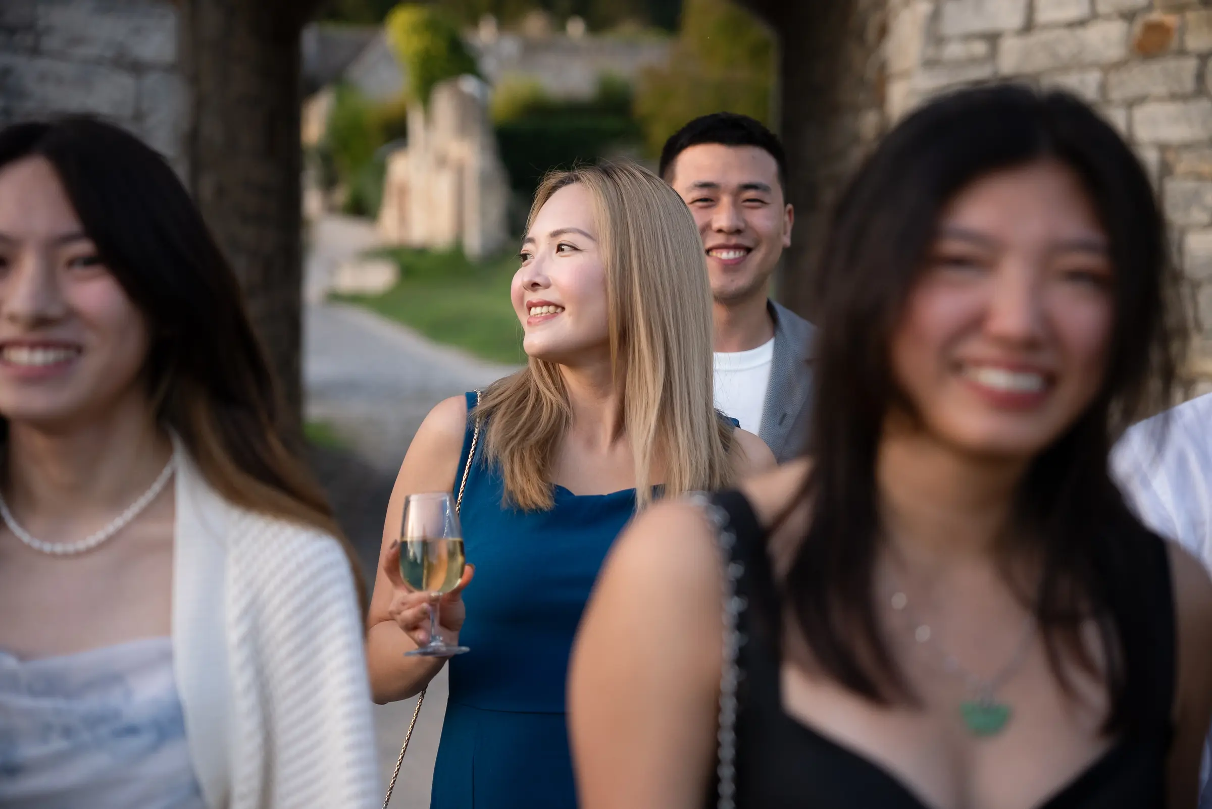 Candid moment among friends holding wine glasses
