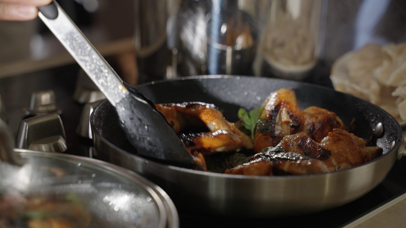 Chicken cooking in a pan on the stove
